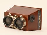 a small wooden box with two binoculars on it