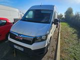 a white van that is parked next to a red car