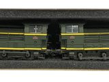 two green and yellow trains sitting in a box