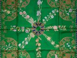a green and gold scarf with a cross on it