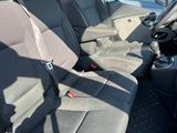 the back seats of a van are empty in a parking lot