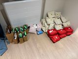 many bags and bags of food on the floor next to a radiator