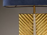 a close up of a lamp with a blue shade on a table