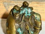 a statue of an elephant with a man riding on it