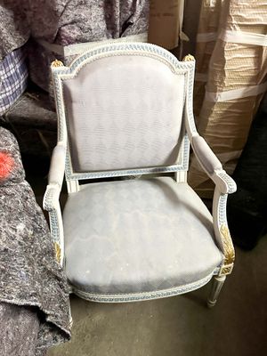 a chair that is sitting in the middle of a pile of boxes