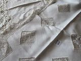 a close up of a bed with a white blanket and a pillow