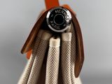 a close up of a purse with a button on it