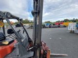 a forklift truck that is parked in a parking lot
