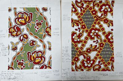 two pages of paper with designs on them on a table