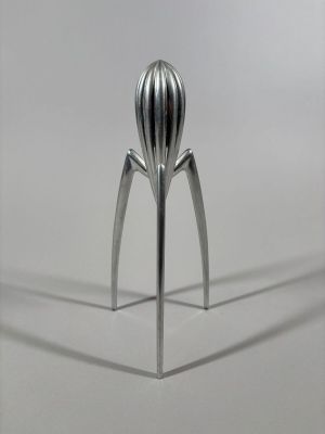 a metal object that looks like a fruit squeezer