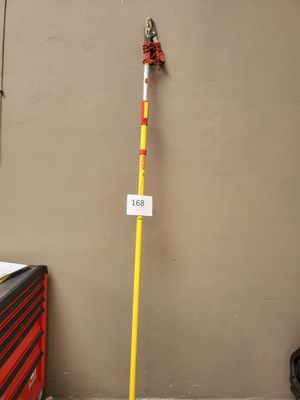 un poteau jaune sur lequel est accrochée une pancarte, à côté d'une boîte à outils rouge