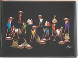 many figurines of people that are standing in a line