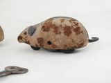 a small toy mouse sitting next to a pair of scissors