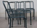 four chairs and a table on the concrete floor