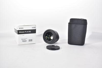 the camera lens is next to a black case and a white box