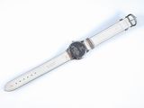 an image of a close up of a wrist watch on a white surface