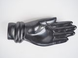 black leather gloves on a white surface with a white background