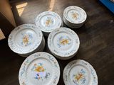 several plates are stacked on top of each other on a wooden floor