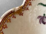 a close up of a bowl with a flower design on it