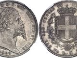 a silver coin with a crown and a cross on it