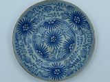 a blue and white plate with writing on it