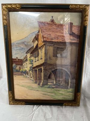 an old picture of a painting of a street with buildings and a mountain in the background