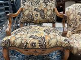 two chairs with floral upholstered cushions in a room