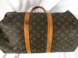 louis vuittoupe travel bag on a bed with a white sheet