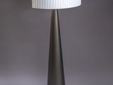 a black and white lamp with a white shade on top of it