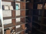 a room with shelves and boxes on the floor