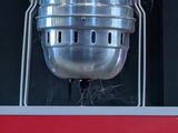 a large metal pot sitting on top of a red box
