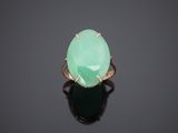 an oval green jade ring with a gold band