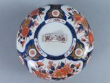 a blue and white bowl with a flower design on it