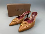 a close up of a pair of shoes with a box in the background