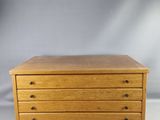 a small wooden chest of drawers on a white background