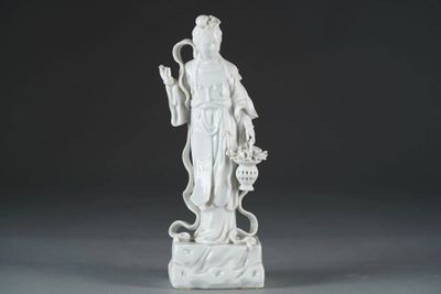 a white statue of a woman holding a basket of flowers