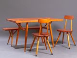 two wooden chairs and a table with a wooden table top