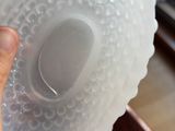 a person holding a plastic object in their hand