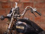 a close up of a motorcycle parked in front of a brick wall