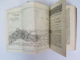 an open book with a drawing of mountains on it