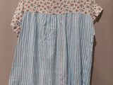 a blue and white striped shirt hanging on a hanger