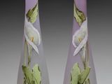 pair of purple vases with white flowers and green leaves on them