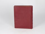 a red book sitting on top of a white surface