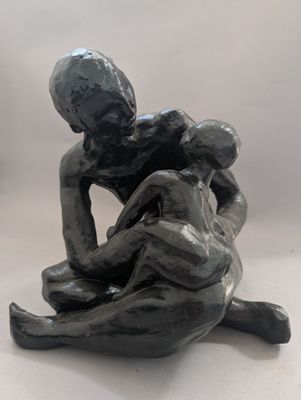 statue représentant un homme et une femme assis l'un sur l'autre
