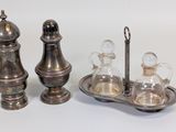 two salt and pepper shakers and a tray of salt and pepper shakers