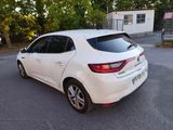 a white car that is parked on the side of the road