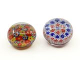 pair of colorful glass paperweight beads on a white surface