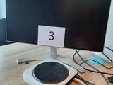 a computer monitor sitting on a table with a number on it