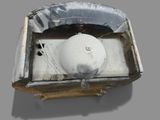 a white ball sitting in a box on a gray surface