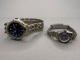 two watches sitting next to each other on a table